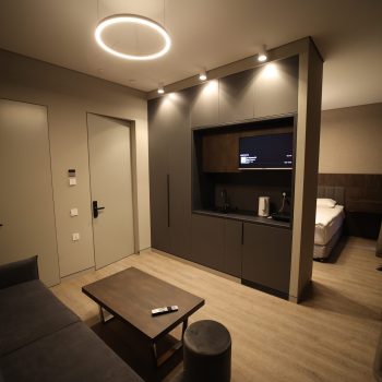 Picture of studio apartment with bed in background